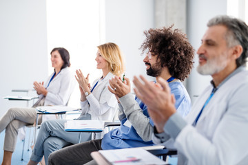 Obraz na płótnie Canvas Group of doctors listening to presentation on medical conference.