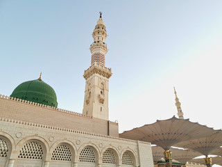Medina, Saudi Arabia - August 25, 2019: Sunrise or golden hour view during haze weather at Nabawi Mosque or Prophet Mosque in Medina, Saudi Arabia.