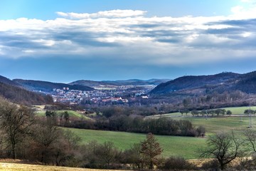 Small town Tisnov in the Czech Republic - Europe. View of the city between hills. February without snow.. Sunny day in the countryside.