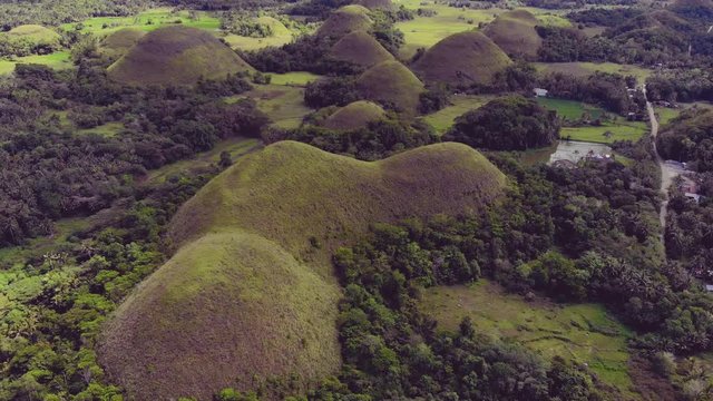 Smoothing aerial drone shot of the chocolate hills in the island of Bohol, Philippines