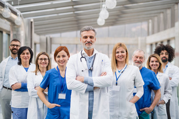 Group of doctors standing in hospital on medical conference. - Powered by Adobe