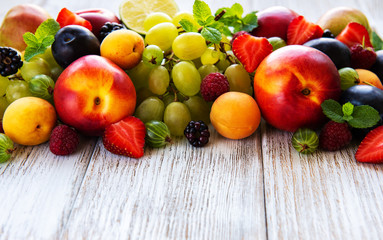 Fresh summer fruits and berries on a white wooden table