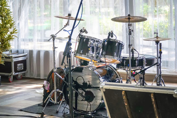 Drum set in a cafe or restaurant before a corporate party or wedding on the background of a large...