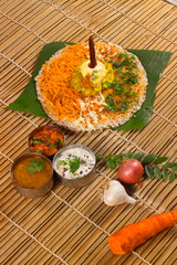 Thick spongy dosas served together with coconut chutney and sambhar on banana leaf