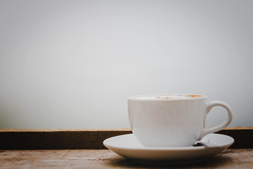 Coffee cup and coffee beans on the table in nature.
