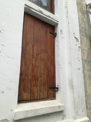 Old wooden door in wall of ancient building from Netherland occupation era in old city in North Jakarta, Indonesia