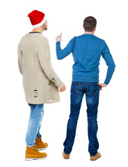 Back view of two man in sweater showing thumb up.