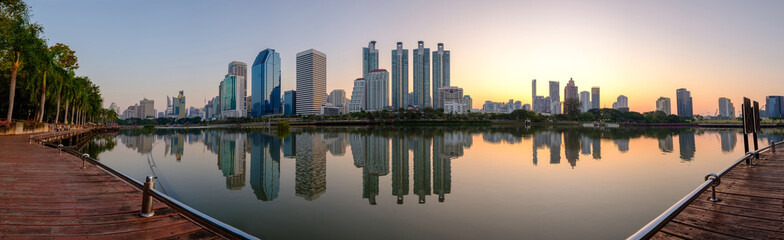 Fototapeta premium Bangkok city downtown at dawn with reflection of skyline
