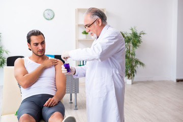 Fototapeta premium Young male patient visiting experienced doctor