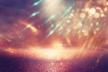 background of abstract glitter lights. gold and black. de focused