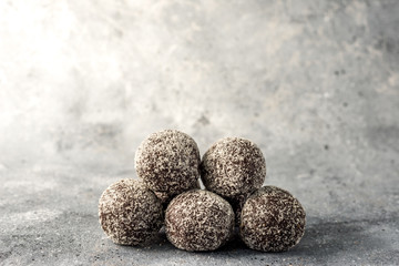 Homemade healthy protein energy balls with dried apricots, raisins, walnuts, almonds and coconut. Healthy sweet food.