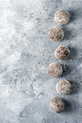 Homemade healthy protein energy balls with dried apricots, raisins, walnuts, almonds and coconut. Healthy sweet food.