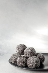 Homemade healthy protein energy balls with dried apricots, raisins, walnuts, almonds and coconut. Healthy sweet food.