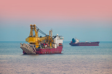 Offshore ship crane in the sea sunset