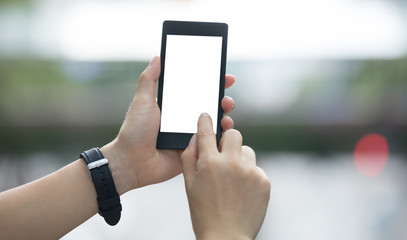 Hands using smartphone in modern city