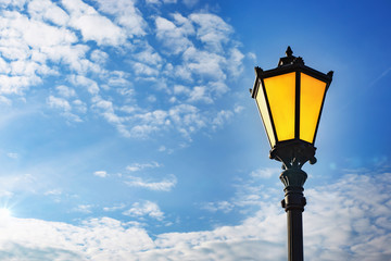 Fototapeta na wymiar Vintage street lamp against the blue sky. Copy space