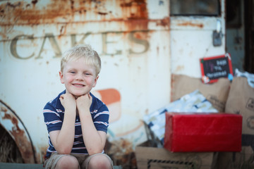 Fototapeta premium Little boy smiling at camera on Christmas themed set