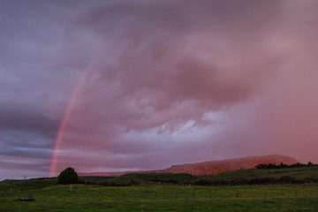 Naklejka na ściany i meble Tongariro National Park New Zealand. Rainbow. Sunset sky