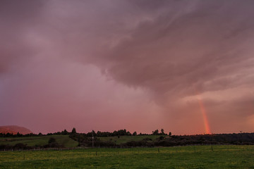Fototapeta na wymiar Tongariro National Park New Zealand. Rainbow. Sunset sky
