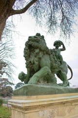 Sculptures of lion and mermaid in front of Alfonso XII monument in Retiro Park in Madrid, Spain