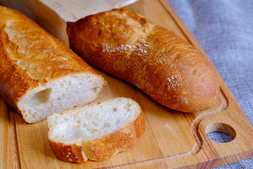Fresh warm baguette with a crispy crust. Sliced for Breakfast. For the morning sandwich.