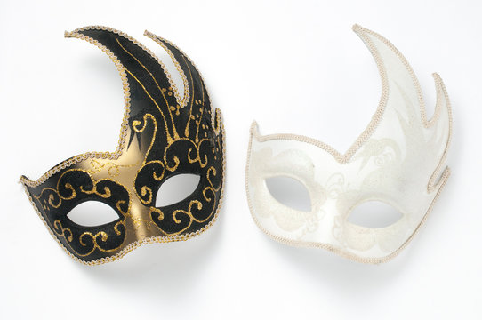 Two black and white theater or mardi gras venetian masks on white background