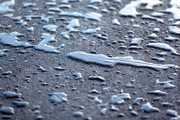 Water drops with ice on asphalt textured abstract background