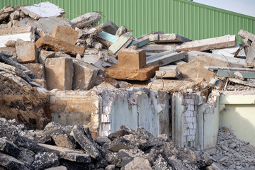 Close-up of demolitioned industrial building with the rubble lying everywhere on the construction...