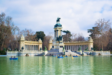 Fototapeta na wymiar large pond of the Retiro and Monument to Alfonso XII in the Retiro Park, Madrid, Spain