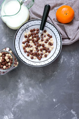 Wholegrain chocolate, milk balls and milk. Healthy cereal breakfast. Baby breakfast. Baby eating. Balanced diet. The top view