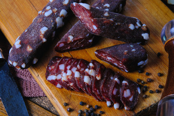 dried pork sausages composition on a wooden background