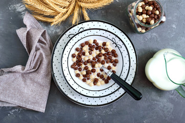 Wholegrain chocolate, milk balls and milk. Healthy cereal breakfast. Baby breakfast. Baby eating....