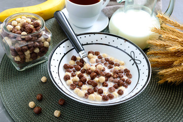 Wholegrain chocolate, milk balls and milk. Healthy cereal breakfast. Baby breakfast. Baby eating. Balanced diet