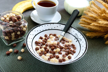 Wholegrain chocolate, milk balls and milk. Healthy cereal breakfast. Baby breakfast. Baby eating. Balanced diet