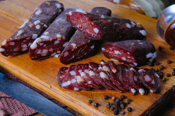 dried pork sausages composition on a wooden background