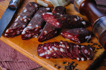 dried pork sausages composition on a wooden background