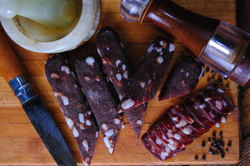 dried pork sausages composition on a wooden background