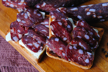 dried pork sausages composition on a wooden background