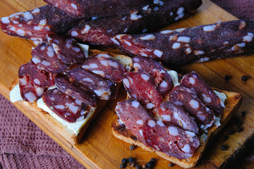 dried pork sausages composition on a wooden background