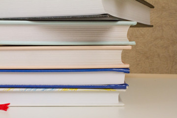 a stack of books and glasses on a white table. the concept of learning, reading, library, University. space for text.
