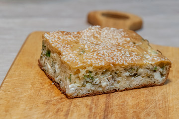 homemade pie with feta cheese and herbs close up