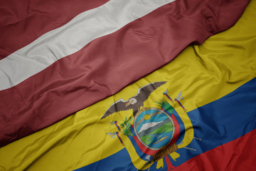 waving colorful flag of ecuador and national flag of latvia.