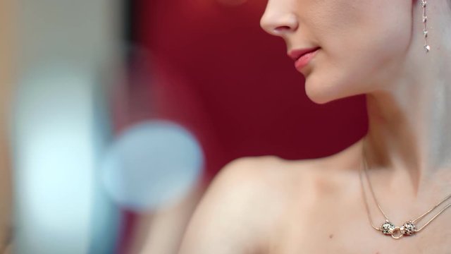 Sexy woman with perfect skin posing at light bokeh background. Close up shot on 4k RED camera