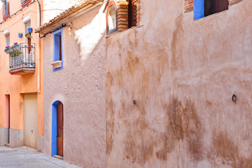 Fototapeta na wymiar Typical house of a town in Catalonia, with the door and the windows with blue frames.