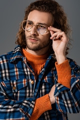Obraz premium handsome man in shirt and glasses looking away isolated on grey