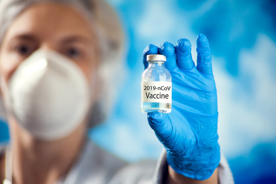Female doctor holding ampula with coronavirus vaccine. Coronavirus, epidemic and healthcare concept