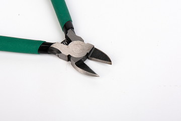Metal tool pliers with green handle on white background