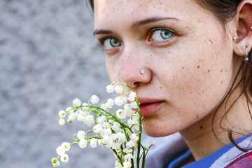 Closeup portrait of the young white girl with freckles and moles. Natural beauty concept.  Freckles woman. Body positive. Freckle face.