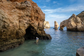 Scenic natural cliff formations and arches of Algarve coastline with turquoise water at Ponta da Piedade, in Algarve Portugal