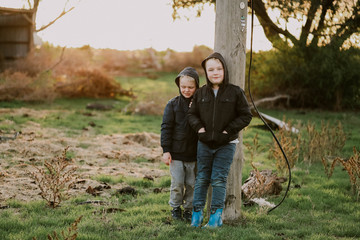 Young brothers exploring abandoned farm in winter